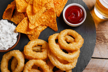 fried onion rings in batter with sauce tortilla chips
