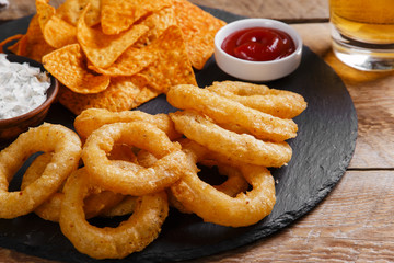fried onion rings in batter with sauce tortilla chips