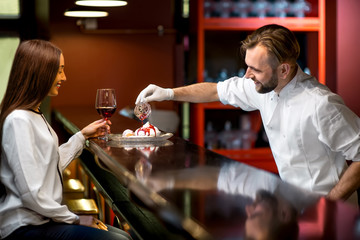 Chef cook serving dessert to the client