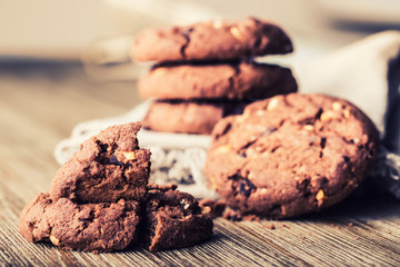 Chocolate biscuit cookies. Chocolate cookies on white linen napkin on wooden table.