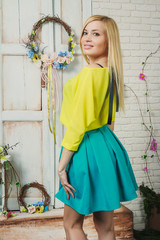 Beautiful young blond woman in the skirt and blouse