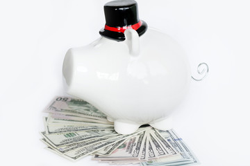 white piggy bank with bowler hat with money on a white background