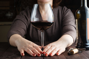 Woman drinking wine in kitchen