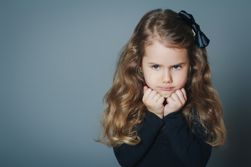 Angry little girl with black bow-knot