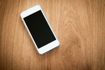 Modern smartphone on a wooden background