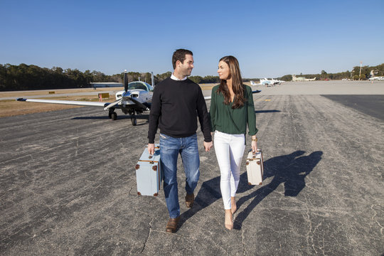 Trendy young couple with plane
