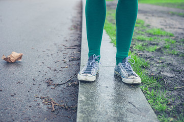 Legs of young woman walking outside