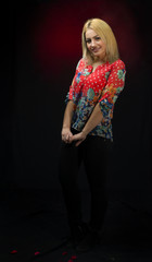 alluring young blonde posing over dark background