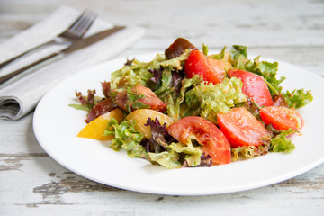 salad of three types tomato with lettuce and sauce