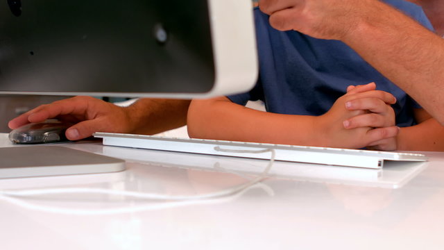 Father and son using computer