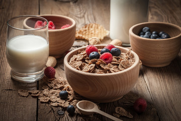 Bowl of cereals with blueberries and raspberrie.