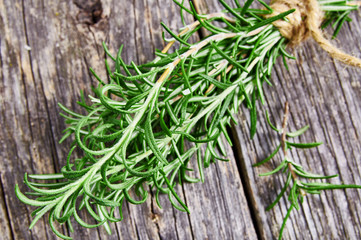 Bunch of fresh rosemary herbs on rustic wooden table