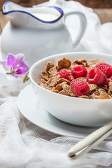 Bowl of cereals with raspberrie.