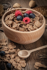 Bowl of cereals with blueberries and raspberrie.