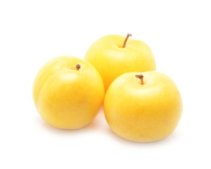 Three yellow plums isolated on white background