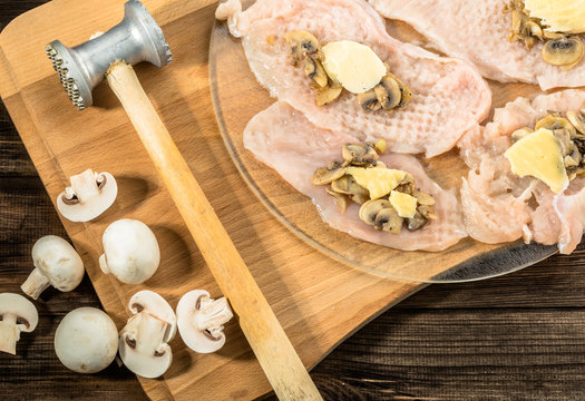 Preparation of chicken kiev from chicken breast stuffed with cheese and champignons