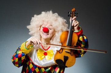 Clown in funny concept on dark background