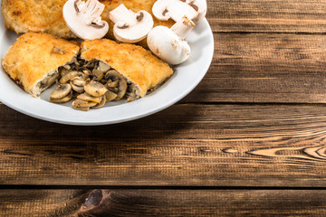 Fried chicken kiev from chicken breast stuffed with champignons.