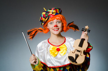 Clown in funny concept on dark background