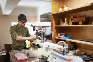 carpenter in a workshop for the drill, In goggles