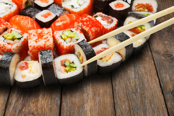 Set of sushi, maki and rolls isolated closeup with chopsticks