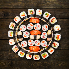 Set of sushi, maki and rolls isolated at wood