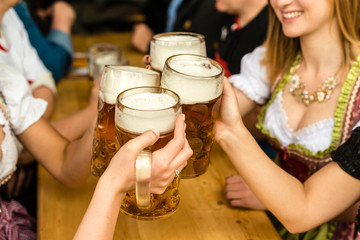 Bavarian girls drinking beer - obrazy, fototapety, plakaty