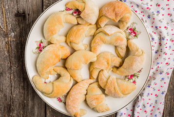 Fresh yeast croissants with marmalade on plate
