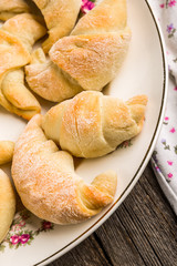 Fresh yeast croissants with marmalade on plate