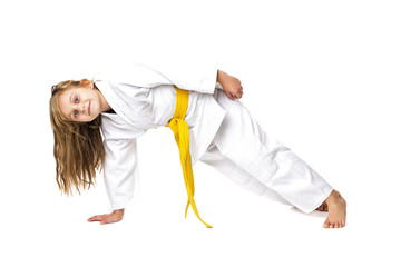 Studio shot of an adorable girl in kimono training martial art