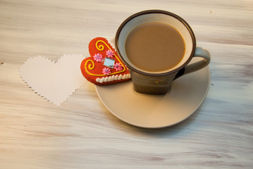 A cup of coffee with gingerbread
