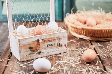 Wooden box with eggs and hay