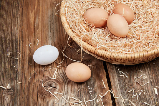 Fresh healty eggs in a nest with straw