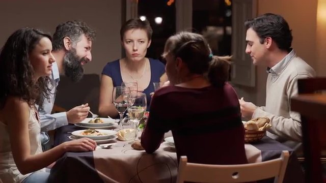 Group of young people dinning together. The camera moves. 4K, UHD