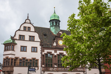 Fototapeta na wymiar People walk on Town hall square in Freiburg im Breisgau, Germany