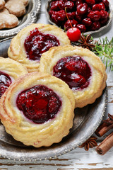 Round marzipan cookies with cherry jam