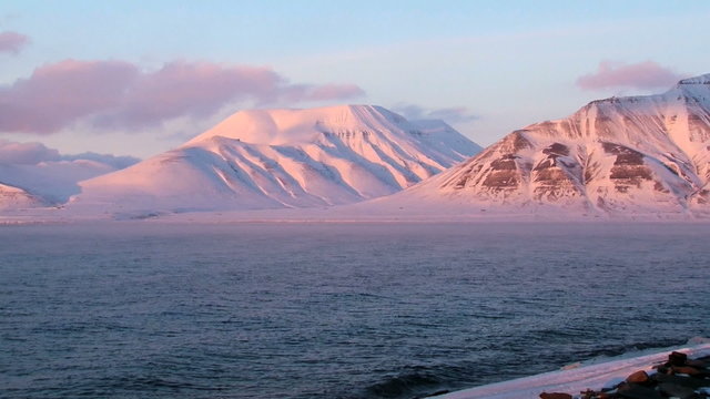 View to the arctic sea shore and mountains at Spitsbergen (Svalbard) archipelago at sunset in spring near Longyearbyen, Norway.