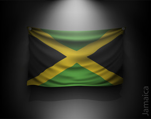 waving flag jamaica on a dark wall