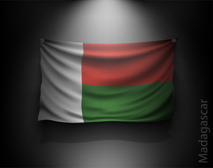 waving flag Madagascar on a dark wall