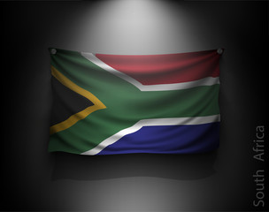 waving flag South Africa on a dark wall
