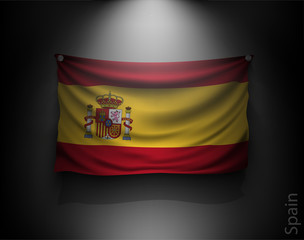 Obraz premium waving flag spain on a dark wall