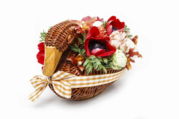 Bouquet of flowers in wicker goose. Table centerpiece