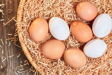 Top view of an easter nest with raw eggs