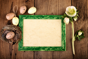 Fototapeta na wymiar Vintage Easter decoration on old wooden board with copy space