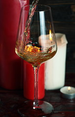 Pouring white wine from bottle into the wineglass