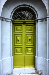 Green door on an old stone building in Malta
