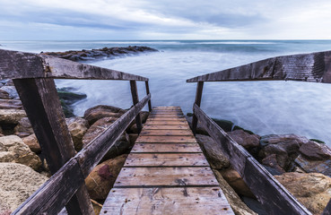 Wooden pier on the sea at sunset