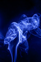 Fototapeta na wymiar Blue smoke on a black background.