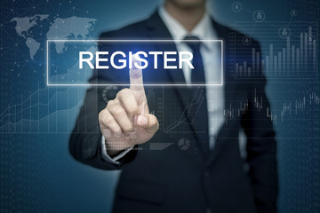 Obraz premium Businessman hand touching REGISTER button on virtual screen