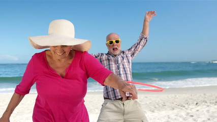 Senior couple doing hula hoop - Powered by Adobe